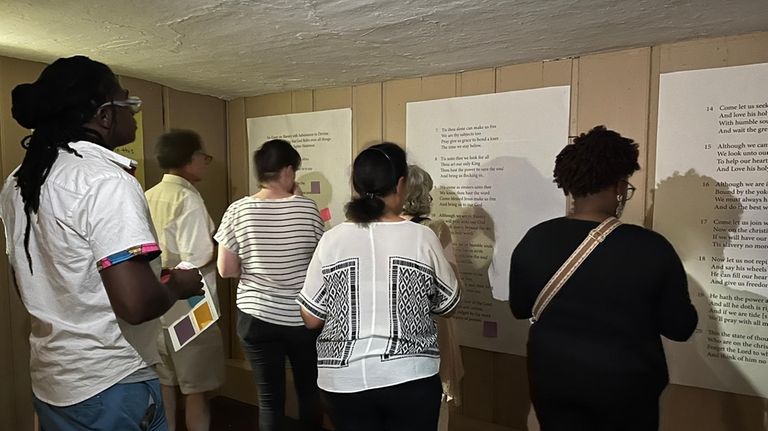 Visitors read Jupiter Hammon’s poetry during a tour of Joseph...