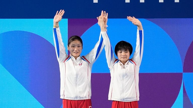 North Korea's Jo Jin Mi and Kim Mi Rae celebrate...