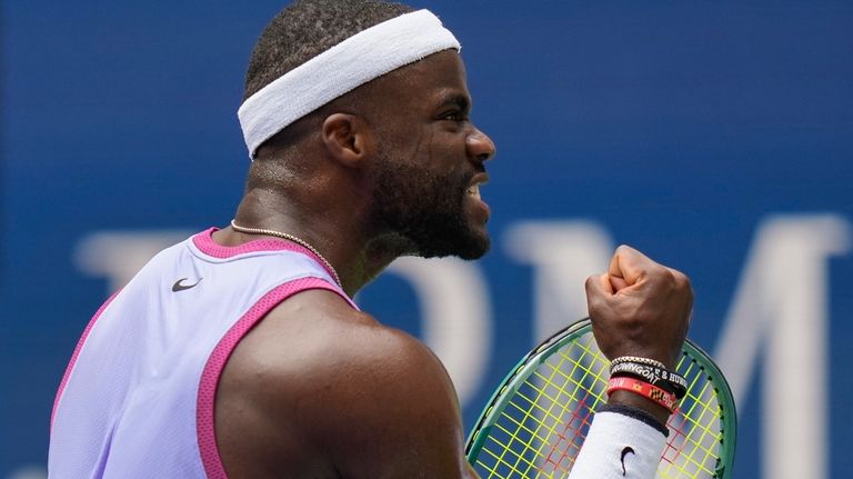 Frances Tiafoe, of the United States, reacts after scoring a...