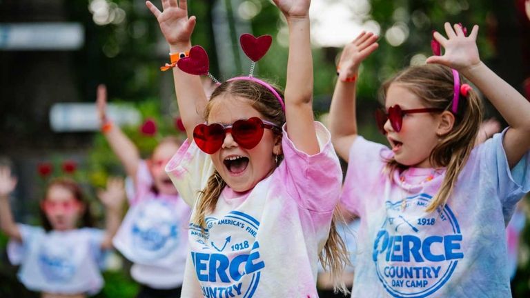 A camp photographer captures Piper Udell and Nellie Stern, both...