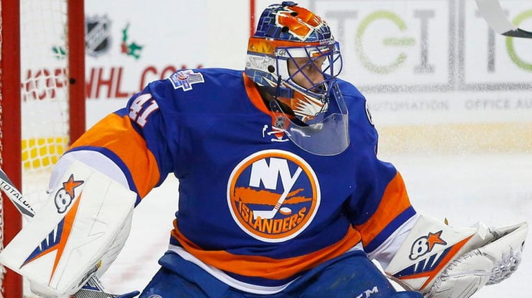 Jaroslav Halak of the New York Islanders makes a save...