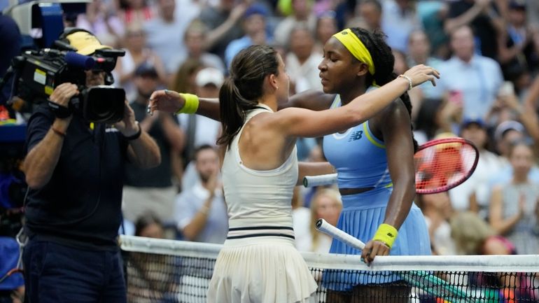 Emma Navarro, center, of the United States, embraces Coco Gauff,...