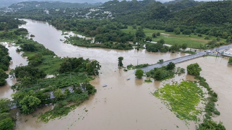 La Plata river floods a road after Tropical Storm Ernesto...