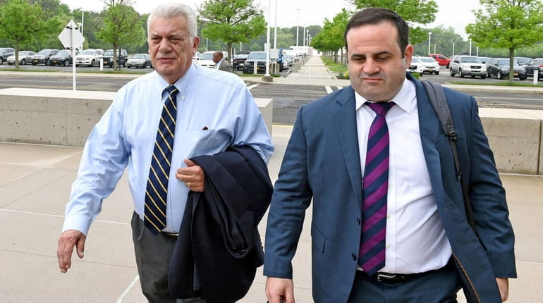 John Venditto, left, arrives at federal court in Central Islip...