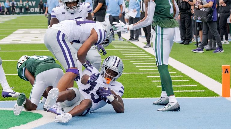 Kansas State safety VJ Payne (19) comes down with an...