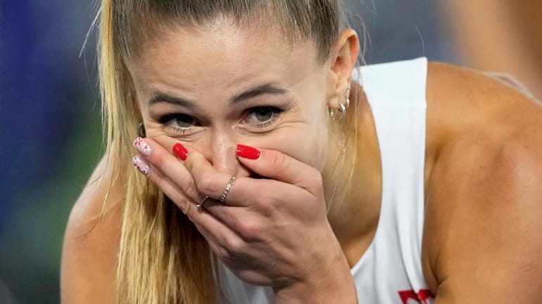 Natalia Kaczmarek, of Poland, reacts after winning the gold medal...