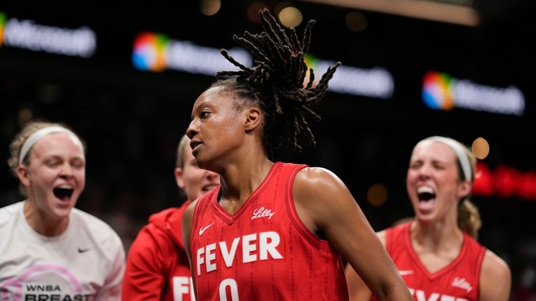 Indiana Fever team reacts to Kelsey Mitchell (0) in the...