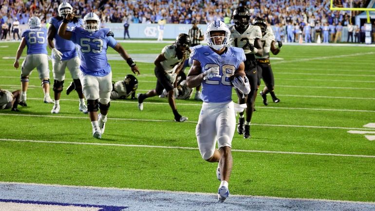 North Carolina running back Omarion Hampton (28) runs in for...