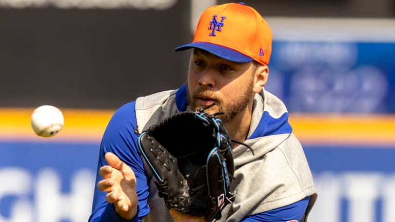 Mets pitcher Tylor Megill works on fielding practice for pitchers...