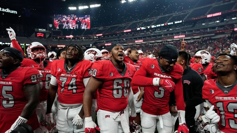 UNLV players celebrate after defeating Vanderbilt in an NCAA college...