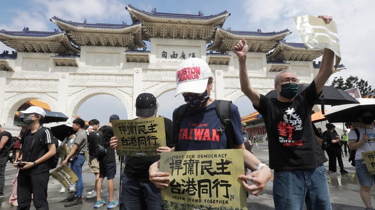 Hong Kong activists and supporters in Taiwan hold a protest...