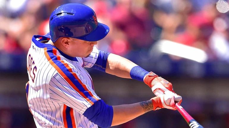 New York Mets third baseman Wilmer Flores (4) swings at...