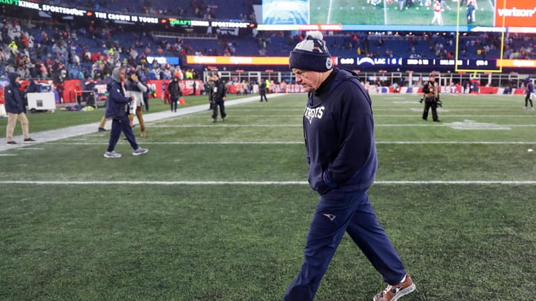New England Patriots head coach Bill Belichick walks off the...