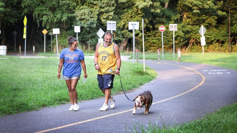 Vanessa and Craig Kittilsen walk with dog Barkley along the...