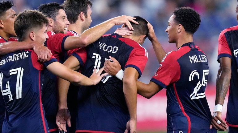 New England Revolution forward Bobby Wood (17) is congratulated after...