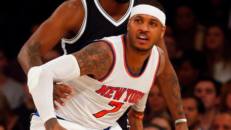 Carmelo Anthony of the New York Knicks battles for position...