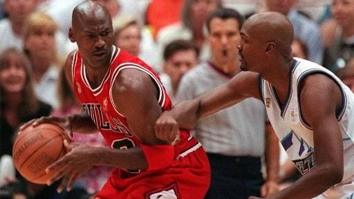 Chicago Bulls' Michael Jordan scowls over his shoulder as he...