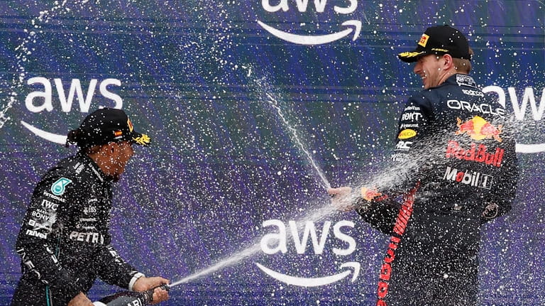 Second placed Mercedes driver Lewis Hamilton of Britain, left, and...