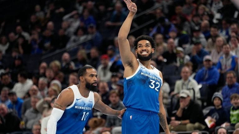 Minnesota Timberwolves center Karl-Anthony Towns (32) reacts after missing a...