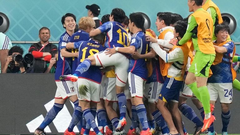 Japan players celebrate after Japan's Ritsu Doan scored his side's...