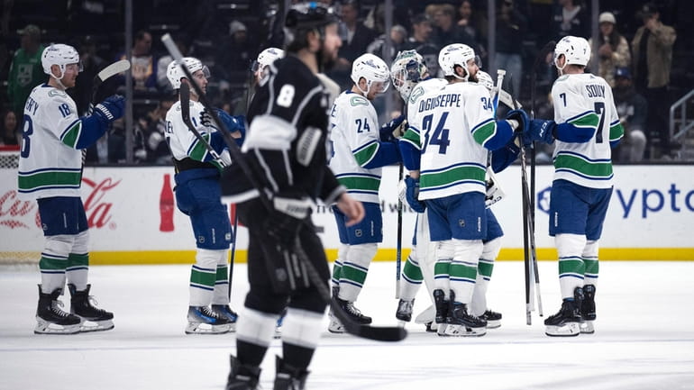 Vancouver Canucks celebrate an overtime win against the Los Angeles...