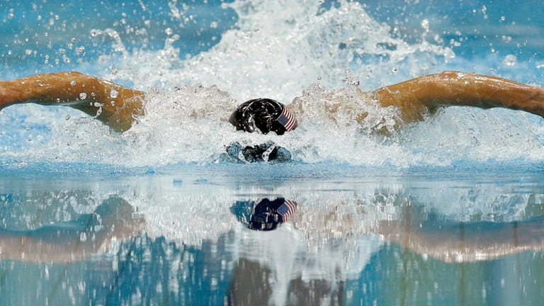 United States' Michael Phelps competes in the men's 100-meter butterfly...