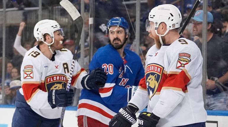 Rangers' Chris Kreider, center, reacts as Florida Panthers' Matthew Tkachuk,...