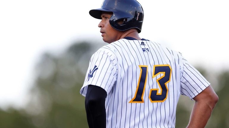 Alex Rodriguez stands on first base after drawing a walk...