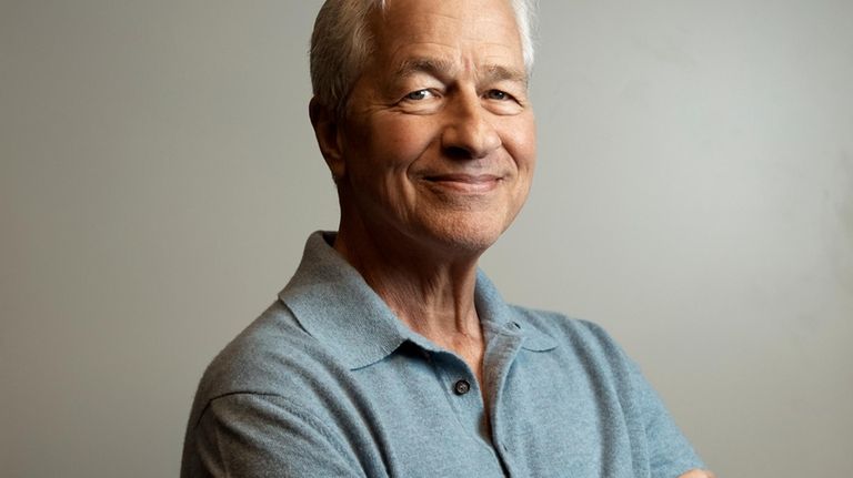 Jamie Dimon, CEO and chairman of JPMorgan Chase, center, poses...