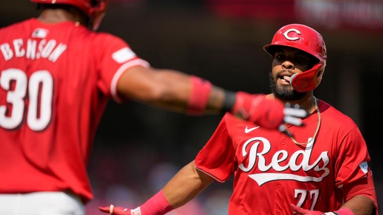 Cincinnati Reds' Rece Hinds (77) celebrates with teammate Will Benson...