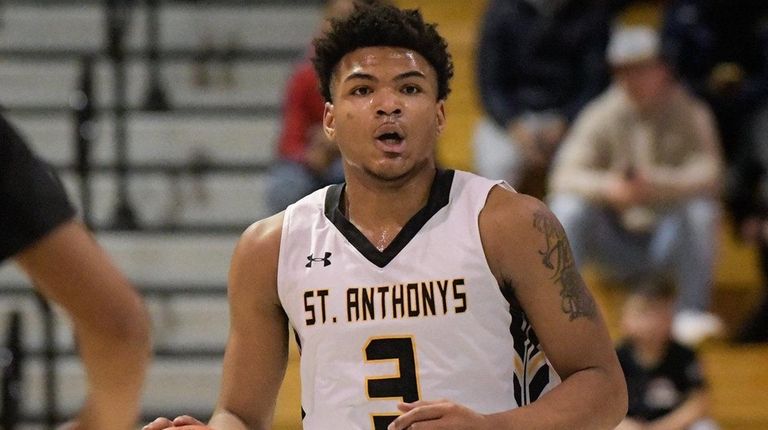 Andre Snoddy of St. Anthony's dribbles down court during the...