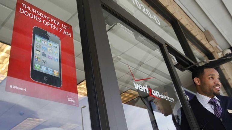 Verizon Wireless store salesman Antione Haynes looks out the front...