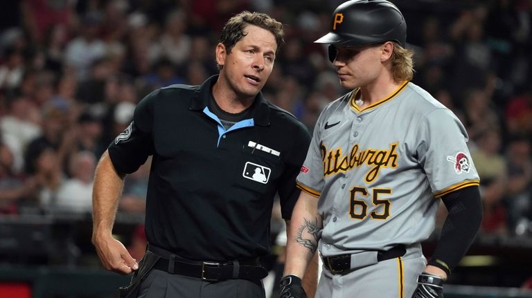 Pittsburgh Pirates' Jack Suwinski (65) talks to umpire Ben May,...