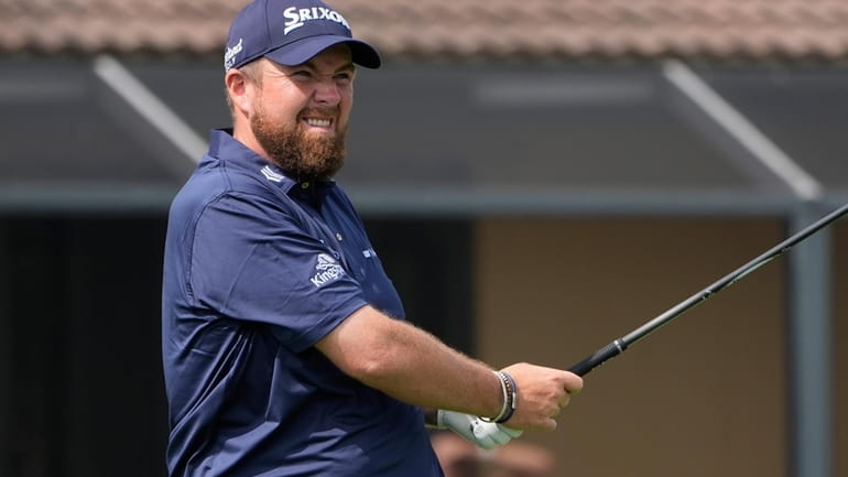 Shane Lowry of Ireland reacts to his shot from the...
