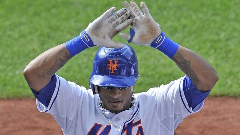 Jordany Valdespin gets ready to high-five his teammates after hitting...