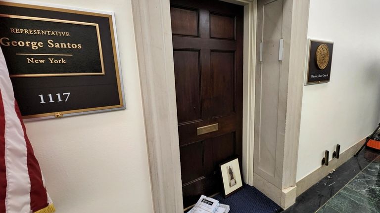 Newspapers and a framed photograph are placed at the office...