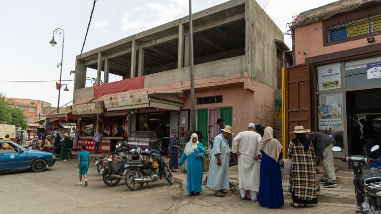 People shop for food at a busy area that was...