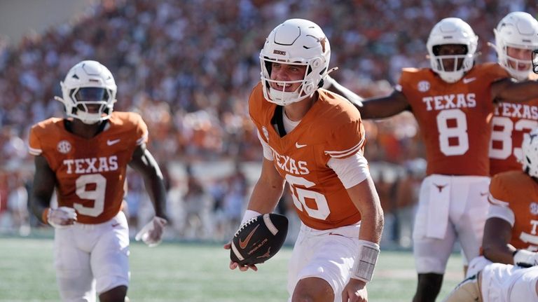 Texas quarterback Arch Manning (16) celebrates after scoring a touchdown...