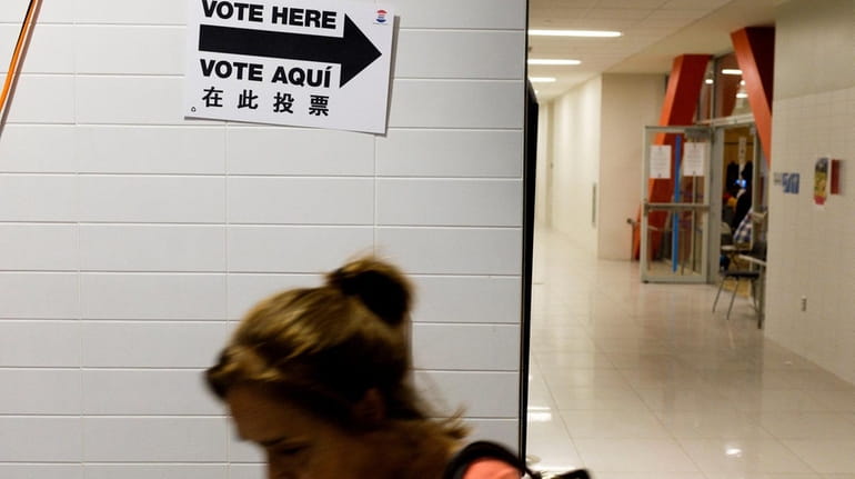 A woman leaves a polling site during primary election voting...