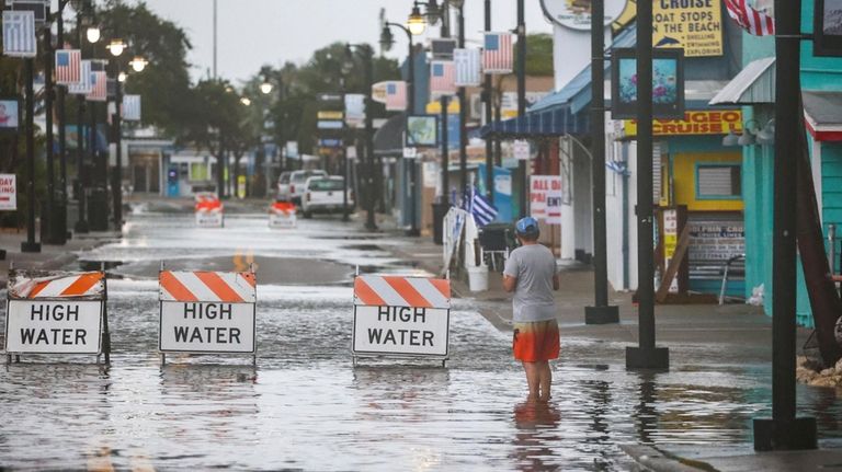 Flood water blocks a section of Dodecanese Blvd at the...