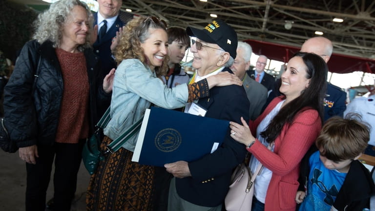 Bob DiChiara is congratulated by his family at the Vietnam...