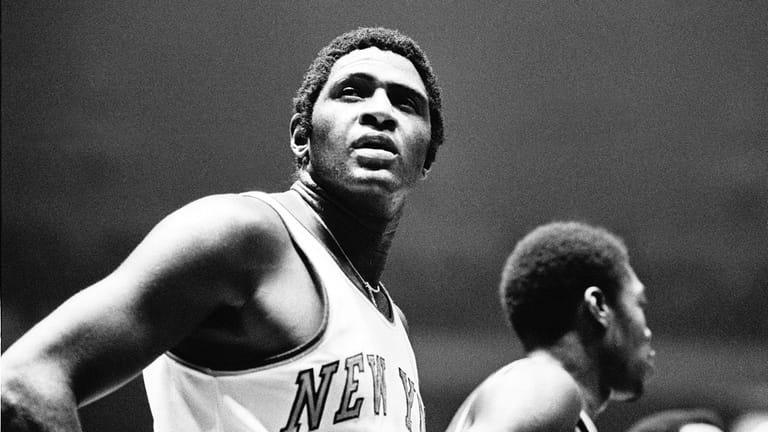 Willis Reed, center of the New York Knicks, takes a...