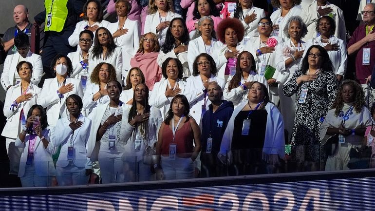 People wear white during the Pleadge of Alliegence during the...