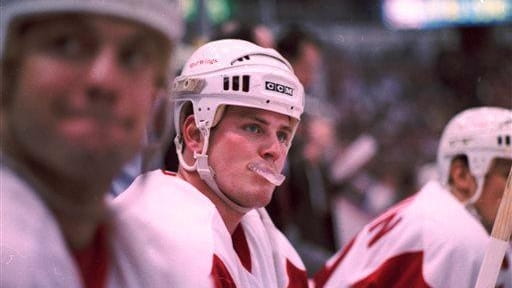 Detroit Red Wings player Shawn Burr bites on his mouthpiece...