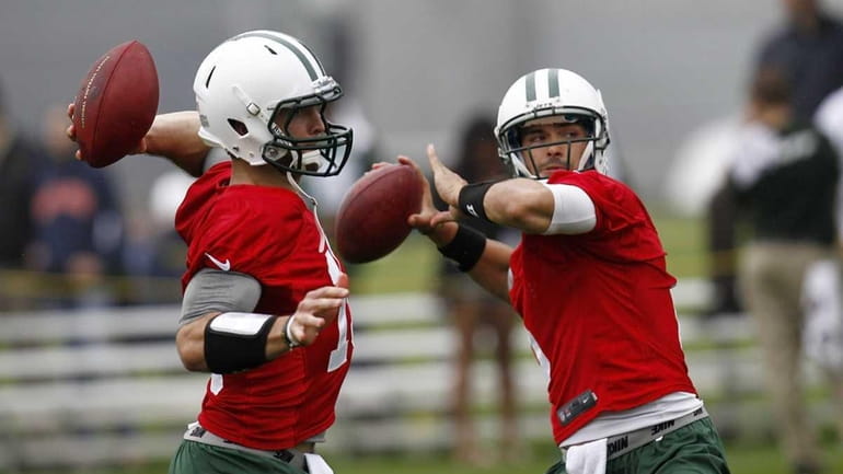 Tim Tebow and Mark Sanchez work out at an organized...