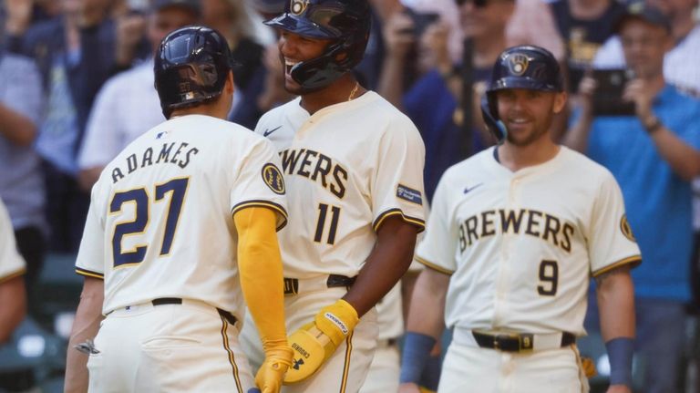 Milwaukee Brewers Willy Adames (27) reacts with Jackson Chourio(11) after...