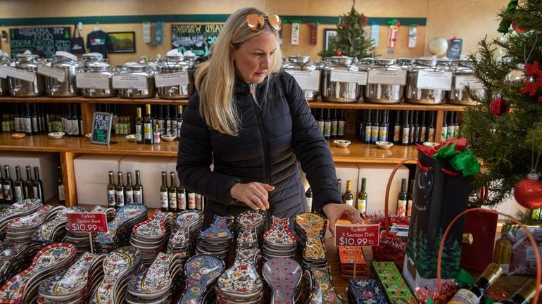 Cheryl Tursi, of Manhattan, browses items at the Amazing Olive...