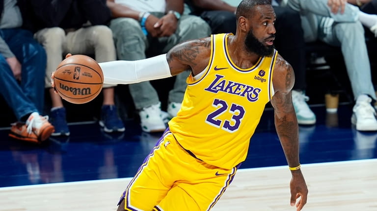 Los Angeles Lakers forward LeBron James pulls in the ball...