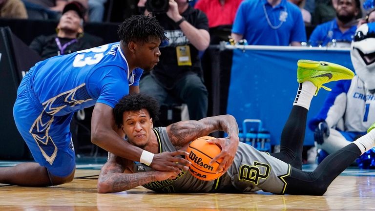 Baylor forward Jalen Bridges tries to keep the ball from...