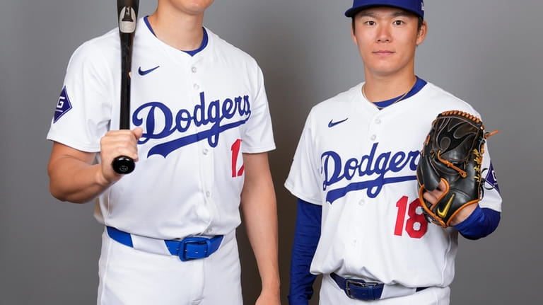 Los Angeles Dodgers designated hitter Shohei Ohtani, left, and starting...